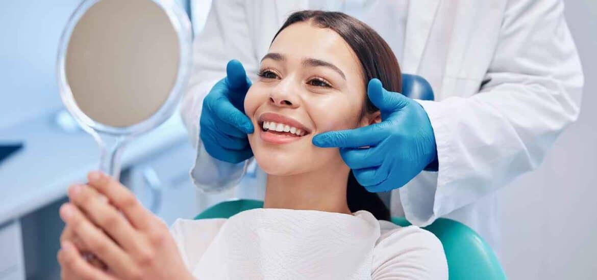 Female Patient Looking Teeth In Mirror At Dental Clinic | Smile Virtual