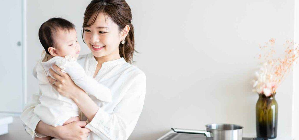 Happy Asian Woman Holding her Baby in Kitchen | Smile Virtual
